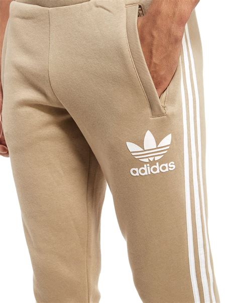 tan adidas sweatpants.